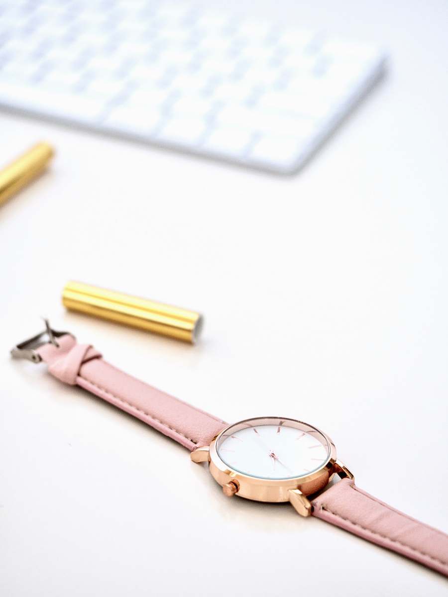 australia round gold-colored framed analog watch on white surface watch